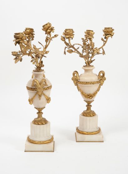 null 
A pair of small ormolu and white marble candelabras, the bouquet of three lights...