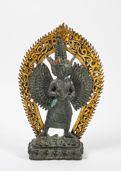 CHINE, XXème siècle - Divinity with multiple arms and heads in front of a mandorla....