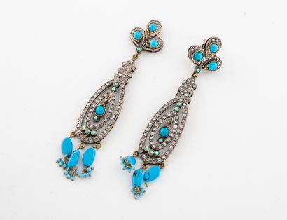 null Pair of silver and gold-plated metal earrings with a three-lobed design holding...
