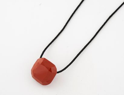 null Faceted red jasper pendant, pierced, on a black braided fabric cord.

Wears...