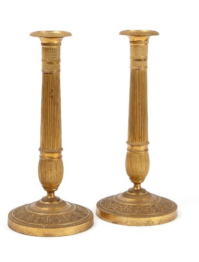 null 
PAIR OF TORCHES 



In gilt brass, the ribbed stem bulging out, the round foot...