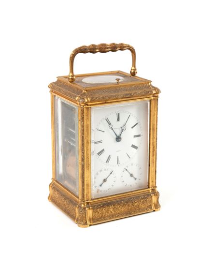 null 
TRAVEL CLOCK Cage type, the gilt brass frame finely engraved with foliage and...