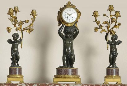null 
CHIMNEY HANDLE In patinated and gilt bronze and porphyry. The clock case, with...
