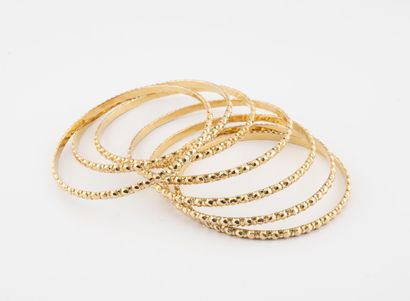 Seven yellow gold (750) bracelets with faceted...