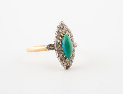 null A yellow gold (750) and platinum (850) marquise ring set with a navette turquoise...