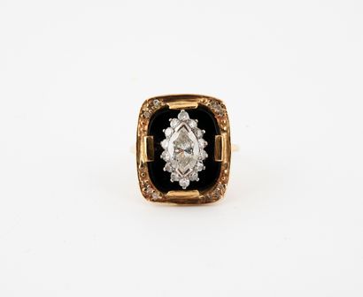 null Yellow gold (585) ring set with an onyx plaque centered with a navette-cut diamond...