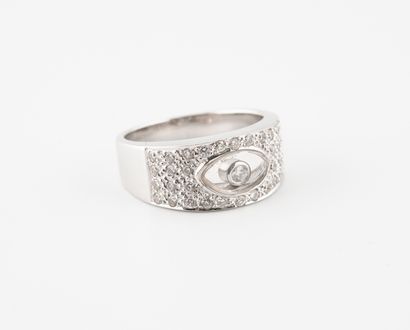 null A white gold (750) band ring centered on a mobile brilliant-cut diamond in an...
