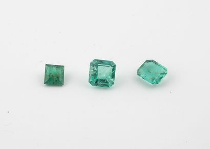 Three emeralds on paper: 
- one emerald cut....