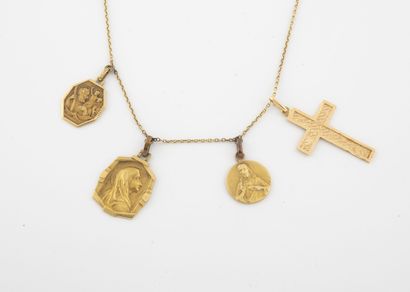 null Yellow gold (750) forçat chain holding four medallions depicting the Virgin...