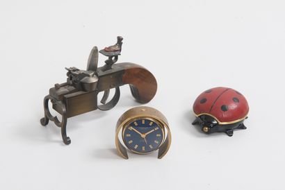 LOOPING, 8 Days Two metal alarm clocks in the shape of a ladybird or an open circle...