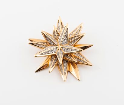 SWAROVSKI Gold-plated metal star brooch decorated with rhinestones in grain setting....