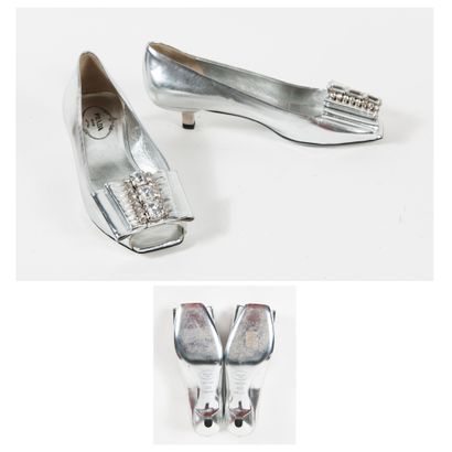 PRADA Pair of silver leather open-toe pumps adorned with a large flat bow centered...