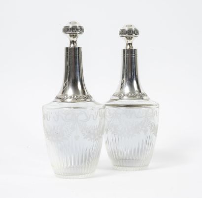 null A pair of cut and engraved glass decanters decorated with knots and garlands...