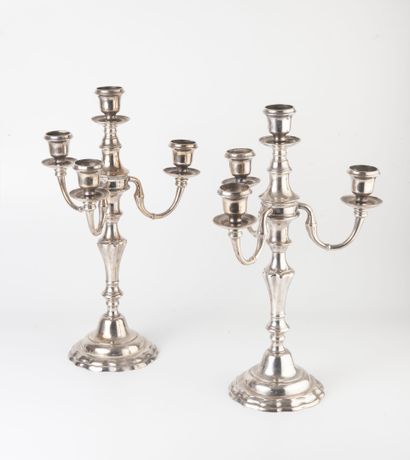 null A pair of silver plated candelabras with three arms of light, the circular base...