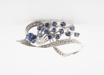 null White gold (750) spray brooch set with round faceted sapphires and a figure...