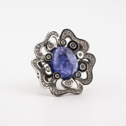  A white gold (750) ring centered on a diamond-set tanzanite cabochon in a setting...