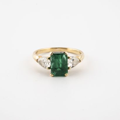 Yellow gold (750) ring set with a step-cut emerald and pear-cut diamonds in a claw...