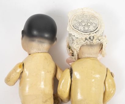 ARMAND MARSEILLE Two Asian twin dolls. 

Full porcelain heads with painted hair,...