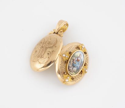 A yellow gold (750) oval pendant with an...