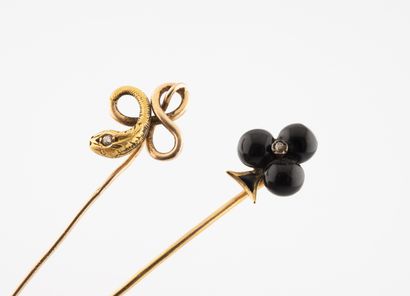 Two yellow gold (750) pins punctuated by...