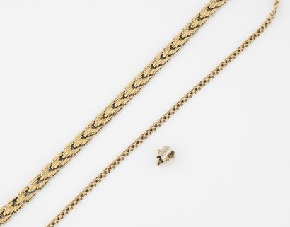 null Two yellow gold (750) bracelets, one with a chain, the other with textured chevron...