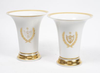 PARIS, XIXème siècle A pair of white porcelain horn vases with gilt decoration of...