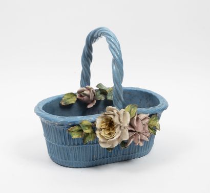 null A blue enamelled ceramic basket with a decoration of roses applied in barbotine....
