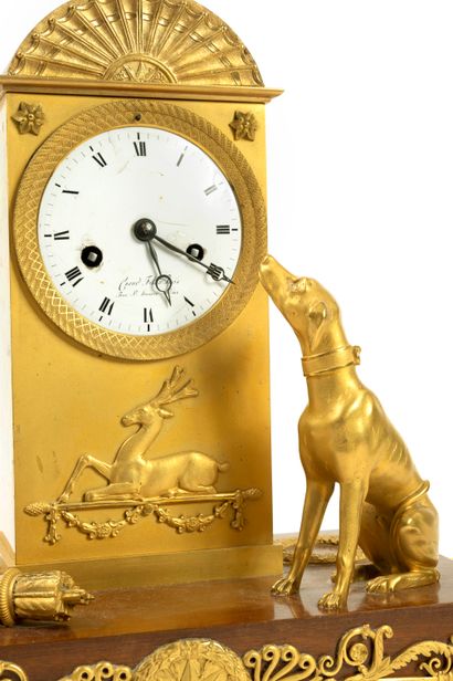 null A gilt bronze and brass clock, decorated with a fan and a stag lying on a thyrse,...