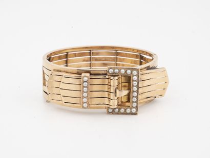 null Opening cuff bracelet in yellow gold (750) with a belt buckle design, highlighted...