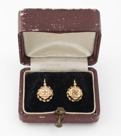  Pair of yellow gold (750) sleepers adorned with white mabe pearls forming a rosette...