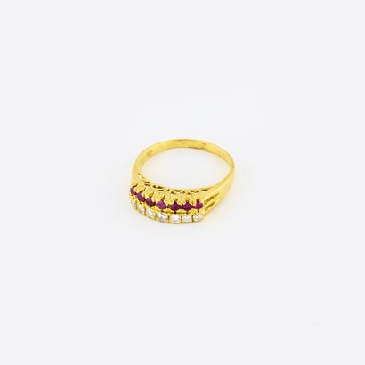 null 
Yellow gold (750) ring set with a line of round faceted rubies and a line of...