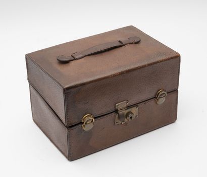 G. KELLER Brown leather travel case containing six bottles of toilet water. 

Moulded...