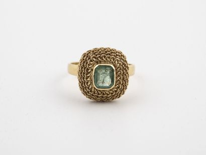 Yellow gold (750) ring centered on an emerald-cut...