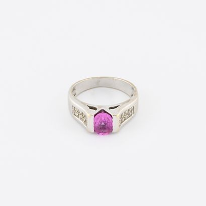 null 
Rhodium-plated yellow gold ring centered on a pink sapphire and set with small...