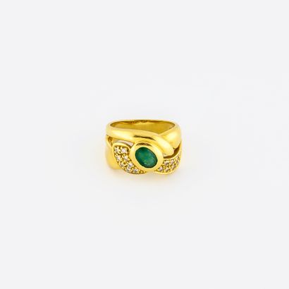 null Yellow gold (750) ring centered on a faceted oval emerald in a closed setting...