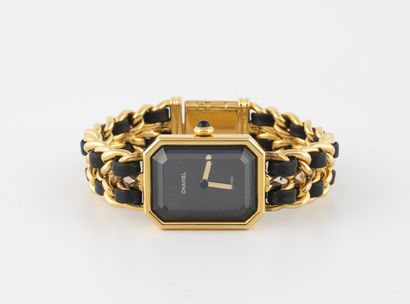 CHANEL, Première Montre bracelet de dame en métal doré et cuir noir.

Boîtier rectangulaire...