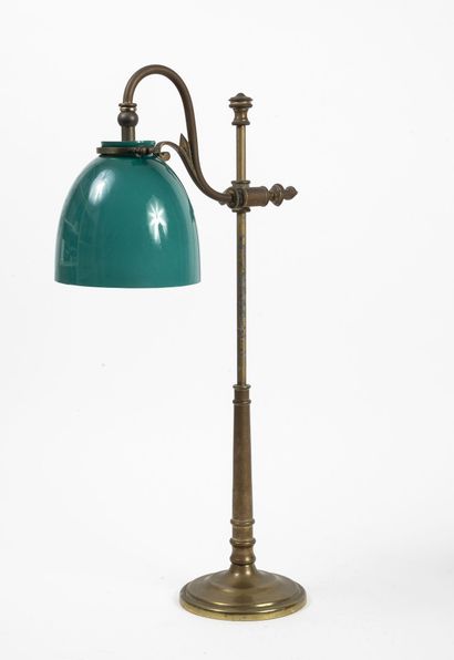  Brass desk lamp with circular base and adjustable arm. 
Shade in green and white...