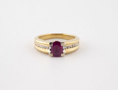 null Yellow gold (750) ring centered on a faceted oval synthetic ruby in a claw setting,...