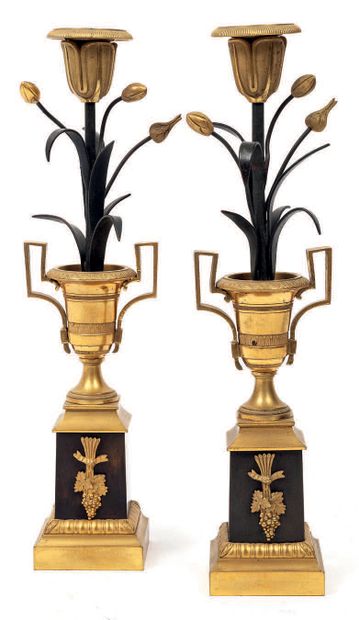 null Pair of green-black patinated and gilded bronze torches in the form of a flower,...