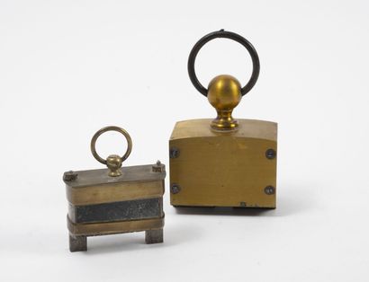 null Two hanging magnets, one with magnet stone, with brass mounts, with rings.

H....