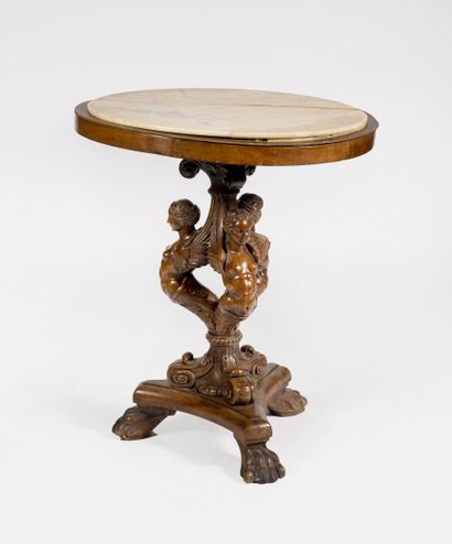 null Pedestal table composed of a late 19th century wooden base carved with three...