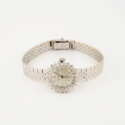 ANTHEOR Montre bracelet de dame en or gris (750). 

Boîtier rond, lunette sertie...