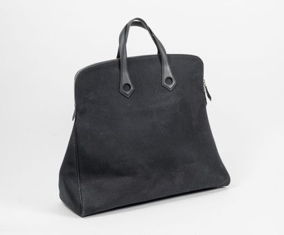 HERMES Paris Heboo travel bag in black canvas and smooth black calf matte. 

Central...