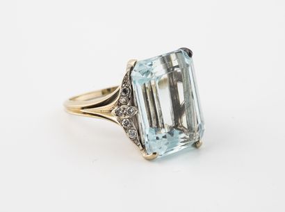 null Rhodium-plated yellow gold ring set with a rectangular faceted aquamarine and...