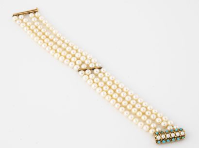 null Bracelet with four rows of white cultured pearls. 

Hook clasp in yellow gold...