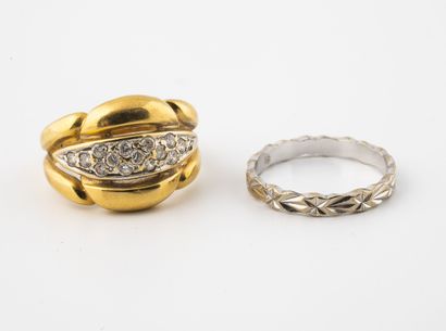 null Lot of two rings:

- A ring in yellow and white gold (750), domed and openworked,...