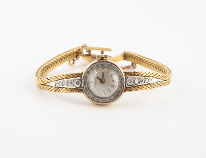 TISSOT Lady's wristwatch in yellow gold (750).

Round case. 

Iridescent white dial,...