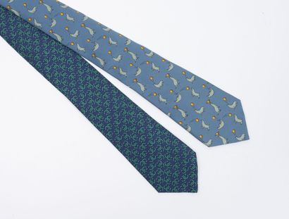 HERMES, Paris Lot including: 

- A silk tie with sea lions playing ball on a blue...