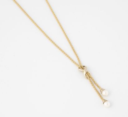 null Yellow gold (750) ball link necklace, the neckline knotted with interlacing...