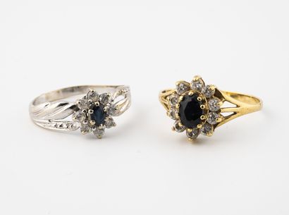 null Two yellow gold (750) or rhodium-plated yellow gold (750) daisy rings, centered...